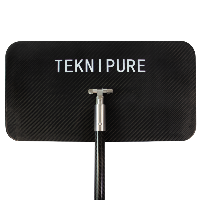 Brand label reading 'TEKNI PURE' on a carbon-fiber panel with a metal assembly attached to a rod beneath.